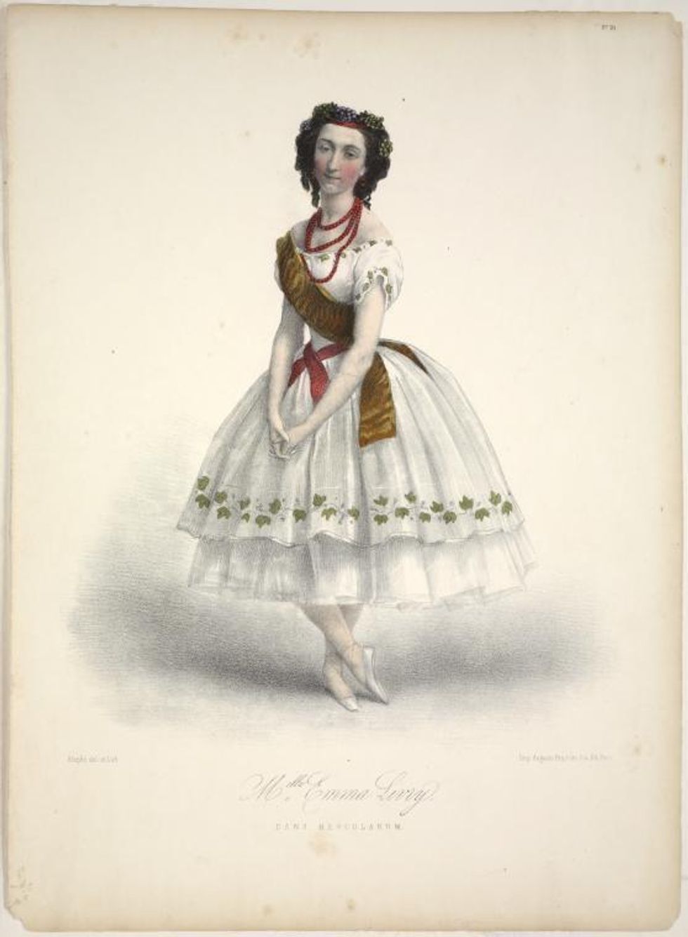 In this antique drawing, a ballerina stands with her arms low with hands clasped gently and her right foot crossed over her left. She wears a white, off-the-shoulder Romantic tutu with a green leaf design trimming the bottom, a gold sash and a red beaded necklace.