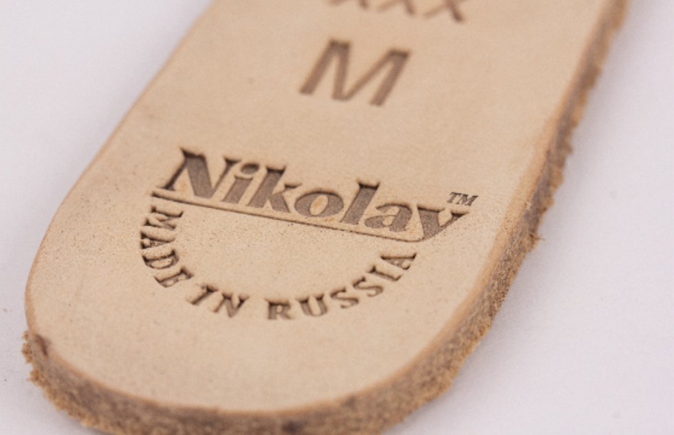 A close up of the bottom of the sole of a pointe shoe, with the size and the words "Nikolay: Made in Russia."