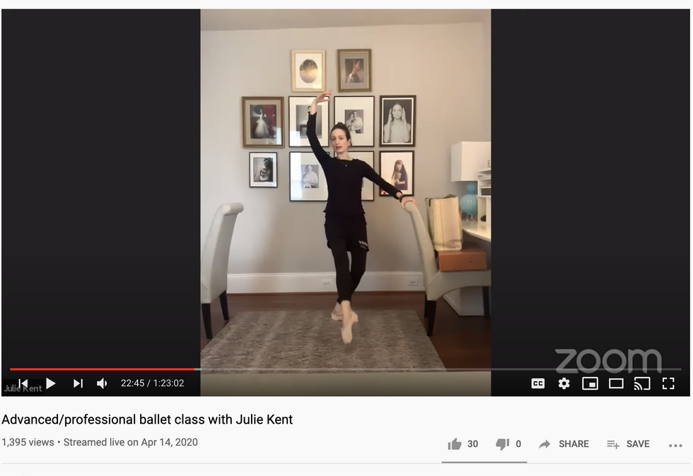 A screenshot of a YouTube video showing Julie Kent, dressed all in black, teaching a barre from her dining room.