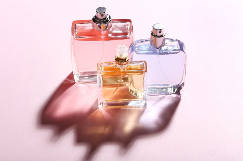Perfume bottles on pink background