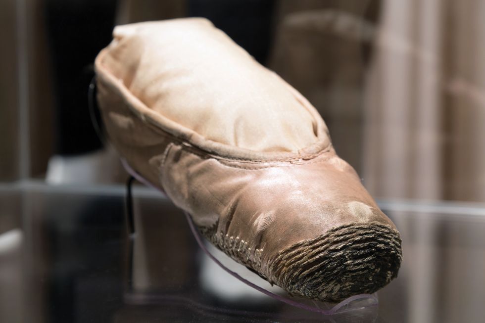 Close up photo of old heavily darned pointe shoe