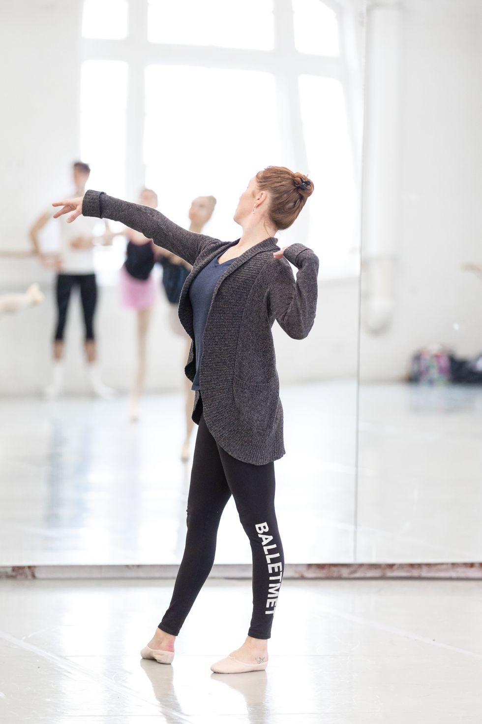 Brooke Moore demonstrates a position at the front of the classroom, exaggerating the u00e9paulement.