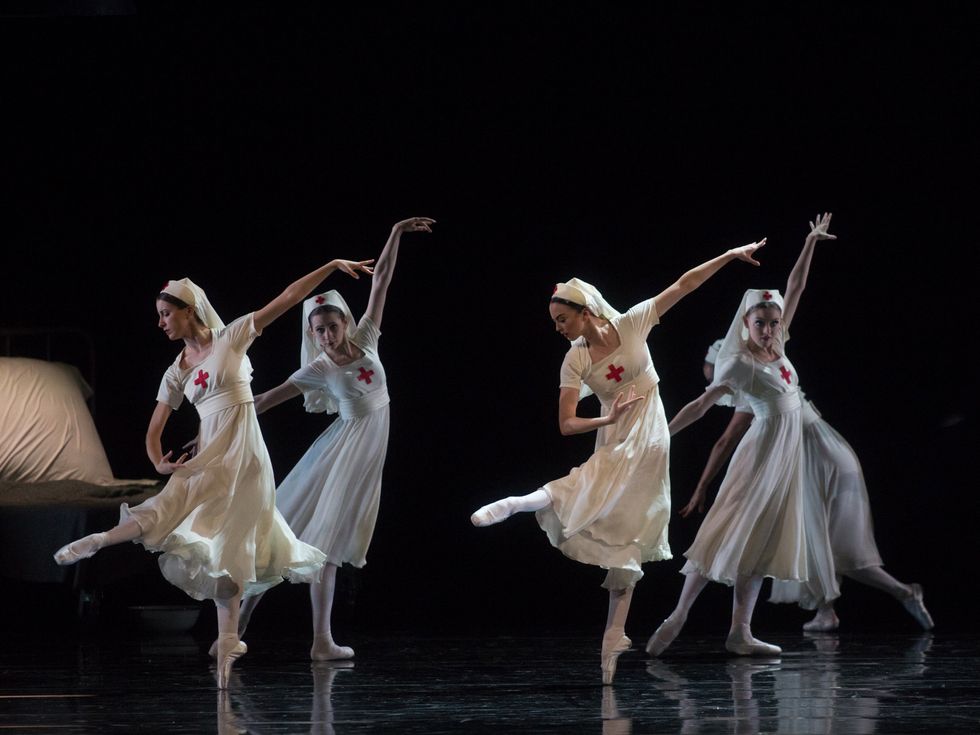 Four dancers in nurse costumes