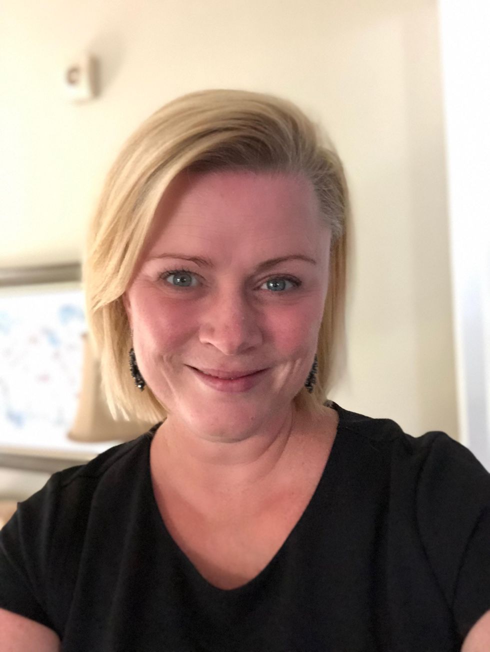 Dr. Jaggers, a white woman with short, blonde hair, smiles for a casual headshot. She is wearing a black, V-neck T-shirt.