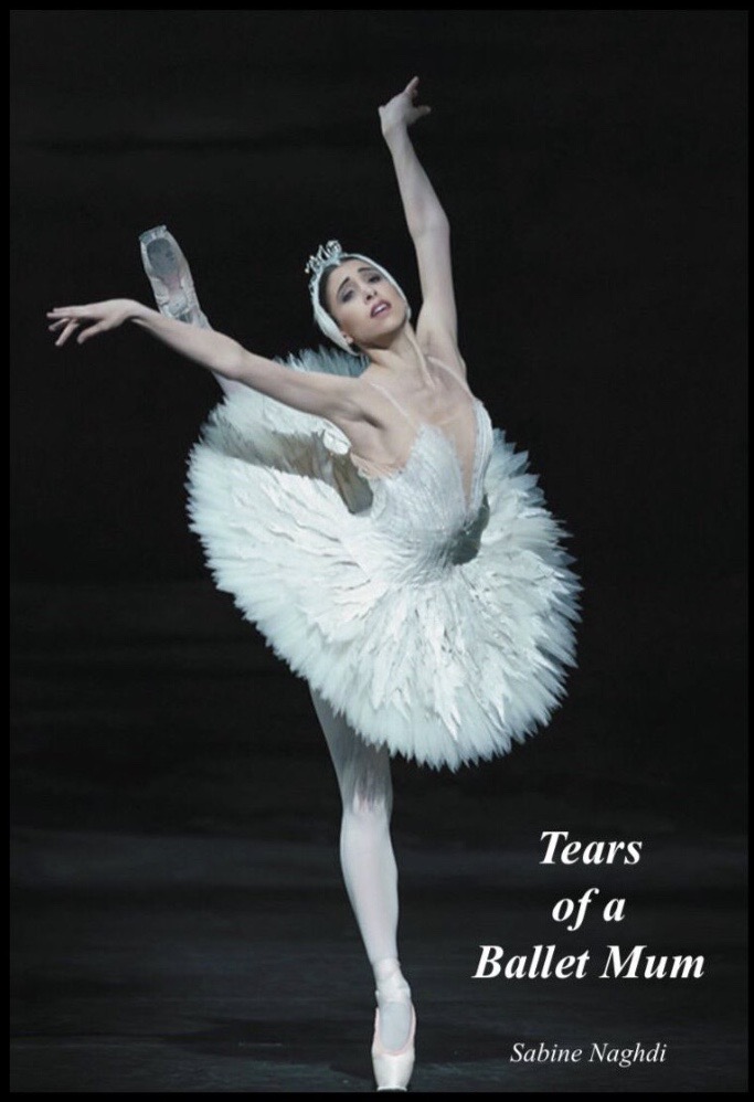 A book cover shows a photo of Yasmine Naghdi in a performance of Swan Lake. She wears a swan tutu and feathered headpiece, and poses in a high attitude derriere on pointe with her arms held in a V-shape. The book title, "Tears of a Ballet Mum by Sabine Naghdi" is in the lower right corner in white lettering.