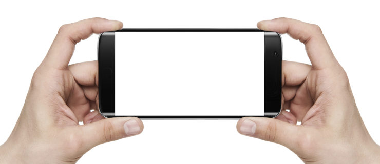 Two hands hold a blank mobile smart phone horizontally.