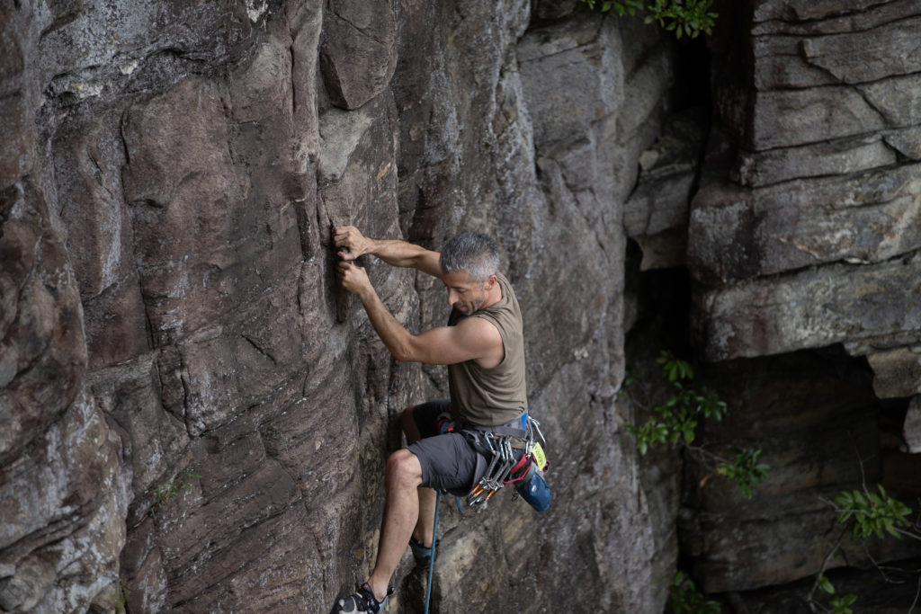 Jared Redick ascends a rock face.