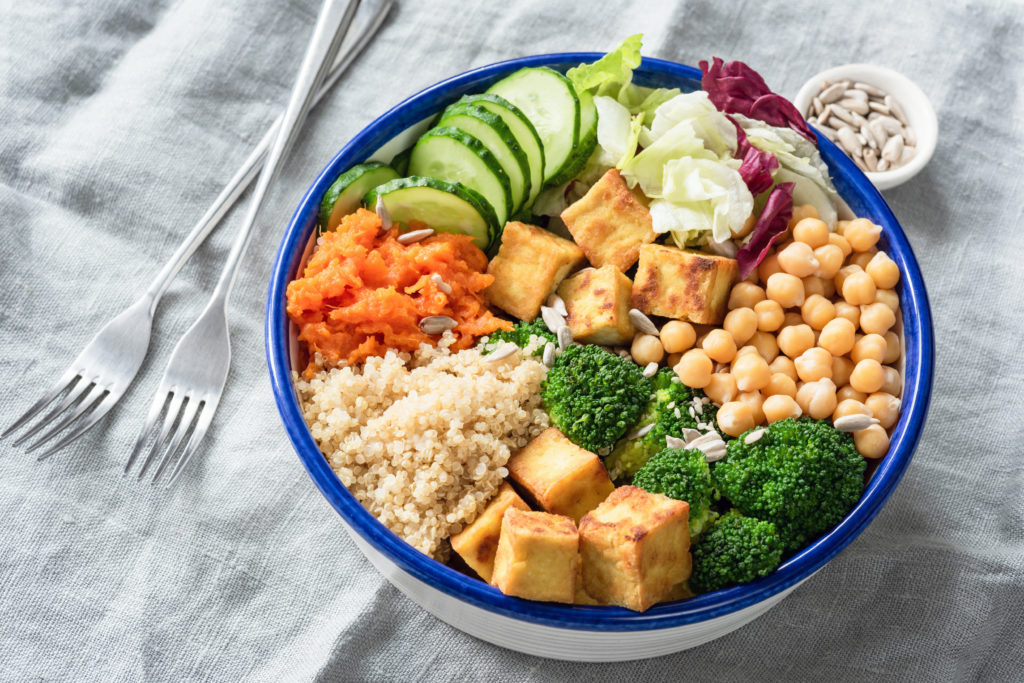 Colorful bowl of quinoa, tofu, chickpeas and a variety of vegetables.