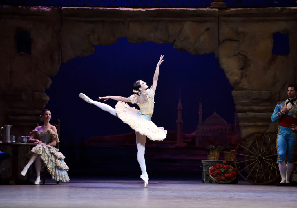 Giangeruso is in arabesque onstage in performance.