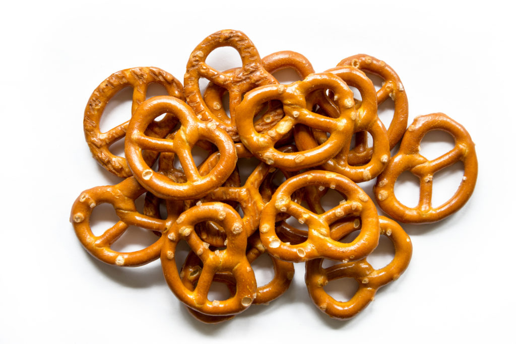 A pile of pretzel loops on a bright white background from an aerial view.