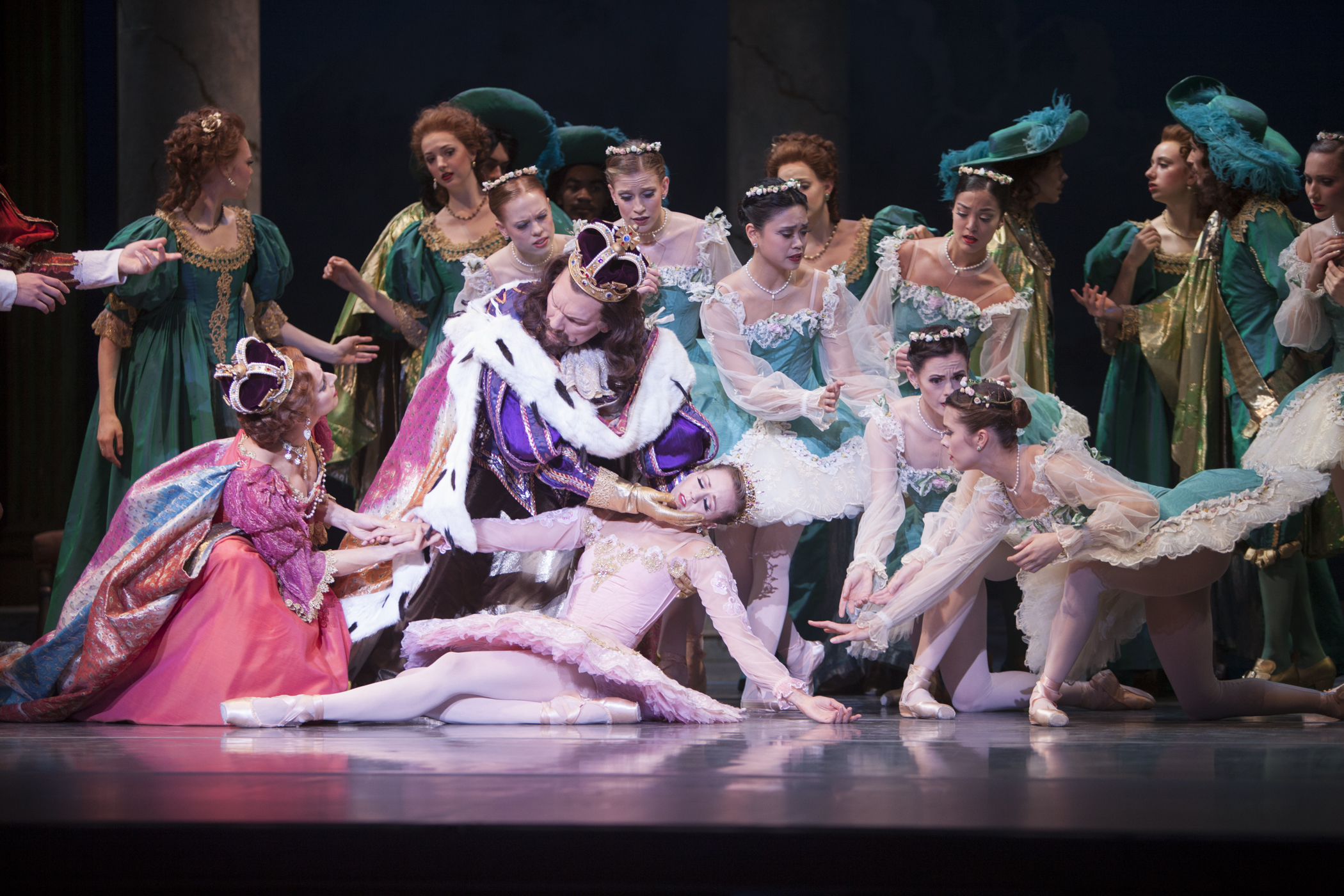 A dramatic moment in The Sleeping Beauty. Beautiful Aurora is in a deep sleep and the king, queen and others surround her with dramatic concern.