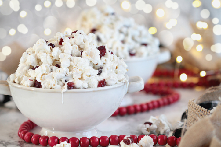 Bowls of homemade popcorn and dried cranberry snack