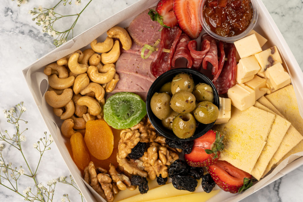 Snack box with nuts, olives, cheese, crackers and meats