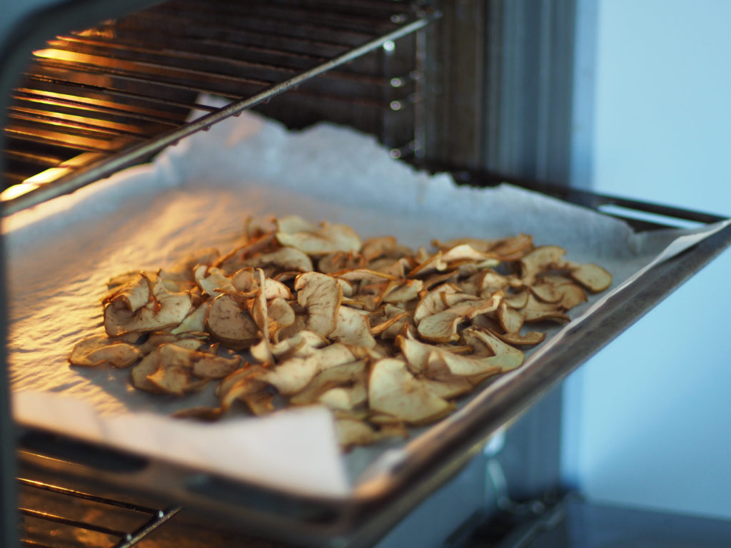 Dried apple chips on a baking sheet