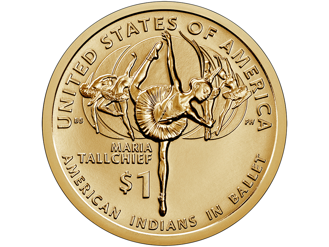 A close-up of the US Native American $1 Coin. A gold coin with a ballerina on center in penche attitude representing Maria Tallchief. Four ballerina figures behind her in various balletic poses, and five phases of the moon behind them all. Around the edge, text reads "United States of America" at the top and "American Indians in Ballet" at the bottom. "Maria Tallchief" and "$1" are printed to the left of Tallchief's supporting leg.