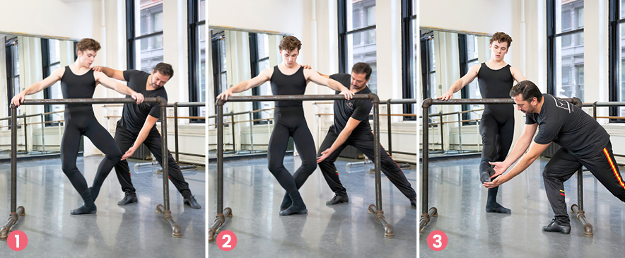 The images shows three side-by-side photos of a male dancer and his coach demonstrating a barre exercise. In the photo on the left, the dancer stands facing the barre with his right leg in plié and his left leg in coupé derriere. The coach holds the dancer's left shoulder and touches his left knee. In the middle photo, the dancer stands in fifth position plié, wit the coach again touching his left shoulder and left knee. In the photo on the right, the dancer brushes his right leg into a dégagé devant, while the coach bends down to hold his foot. Both of them wear black dance practice wear..