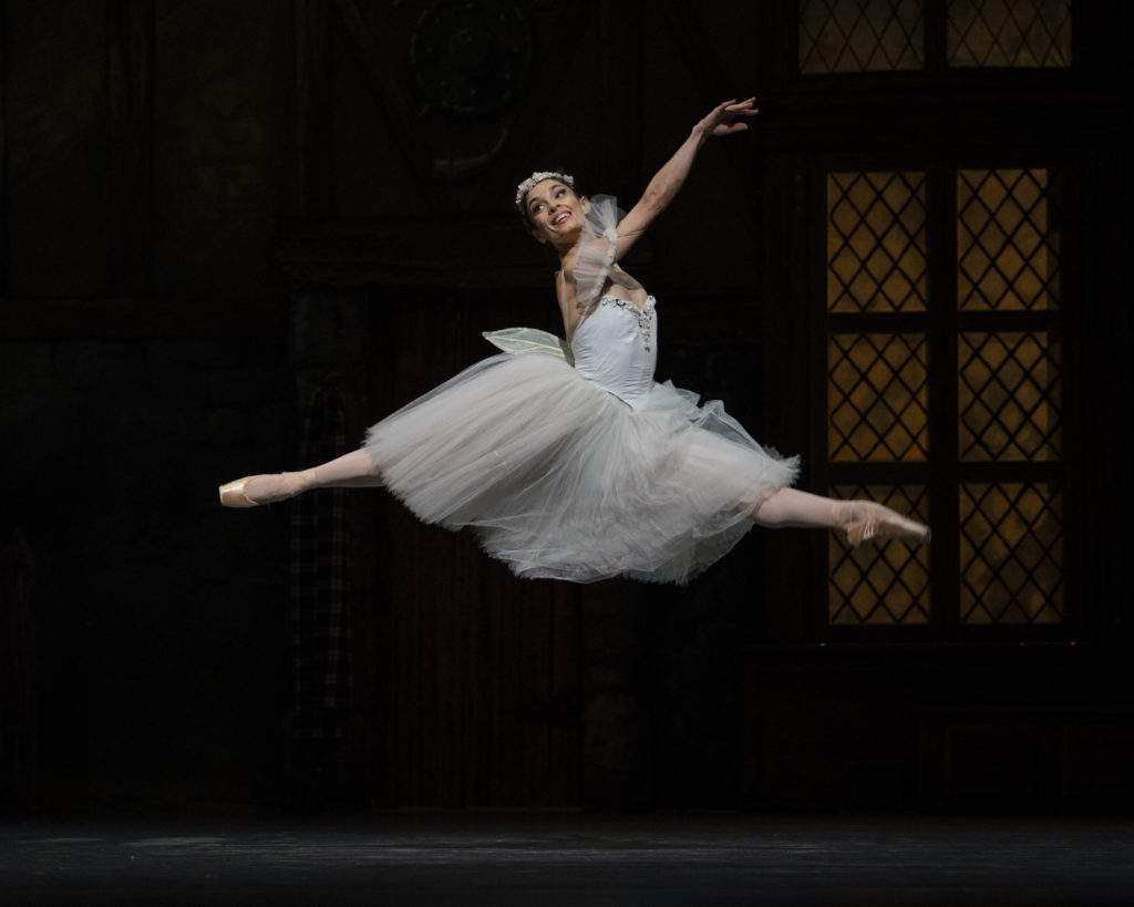 Dores André smiles brightly as she saut de chats across the stage in a wispy white romantic tutu. She performs the title role of "La Sylphide."