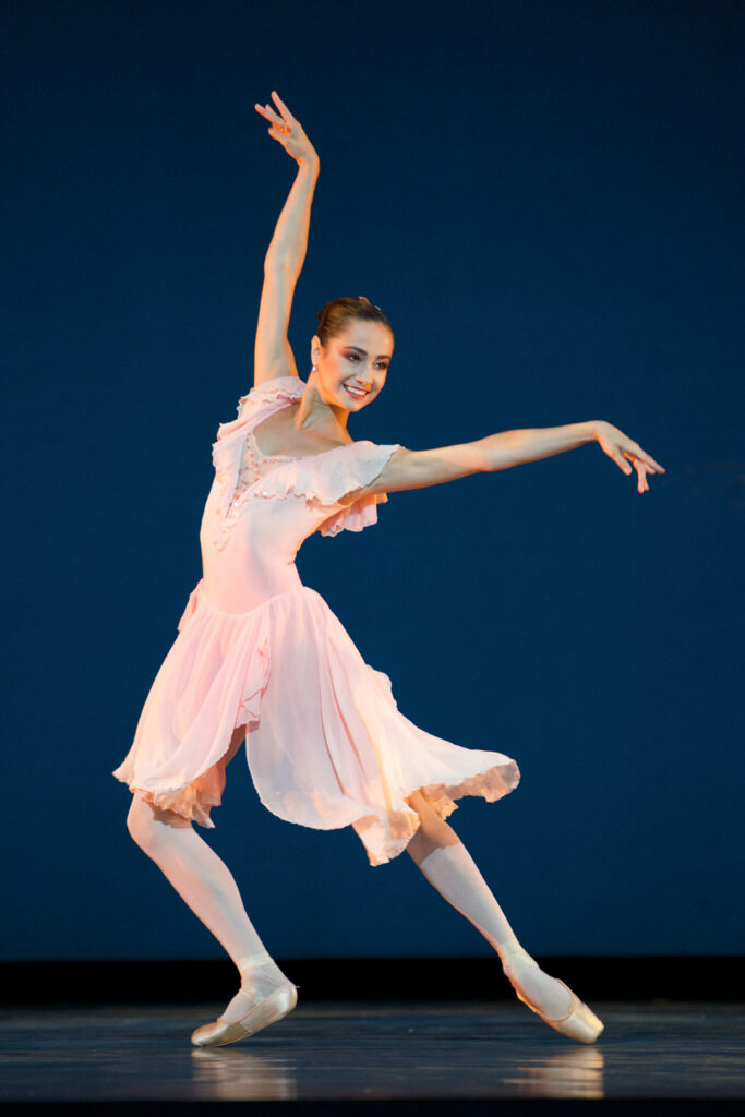 Mathilde Froustey performs in Balanchine's Brahms-Schoenberg Quartet. She does a dragging lunge in a flowing light pink dress.