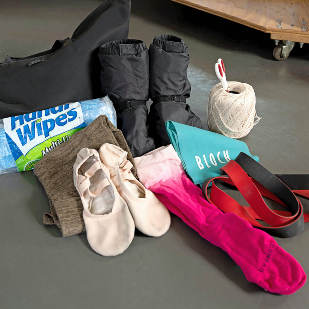 Christine Shevchenko's Bloch boots, compression socks, resistance band, ballet slippers, sewing items, legwarmers, and Handi Wipes.
