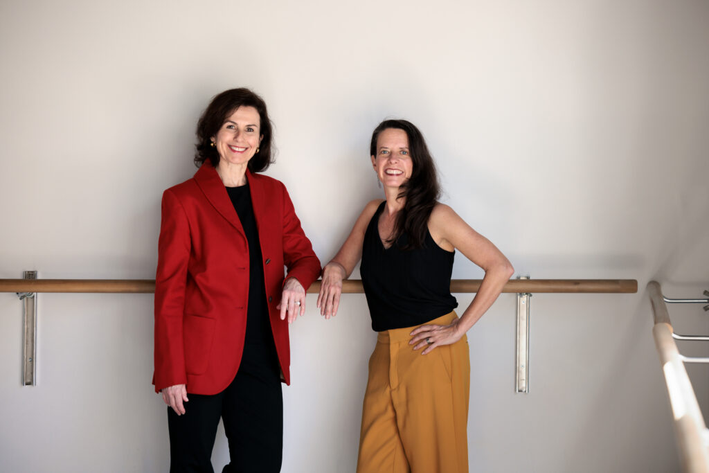 Smuin Artistic Director Celia Fushille and Associate Artistic Director Amy Seiwert pose together in the main studio of Smuin Center for Dance, located in San Francisco's Potrero View neighborhood
