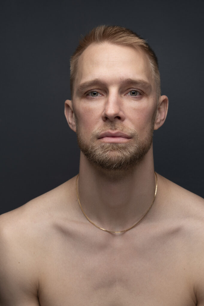 Pontus Lidberg, shown shirtless chest-up, poses for a serious portrait photo.