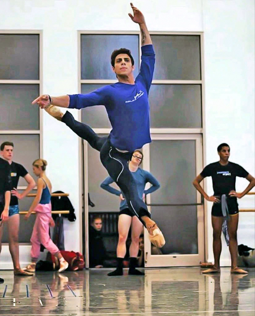 Jaime Diaz dances in a studio with other dancers in the background.