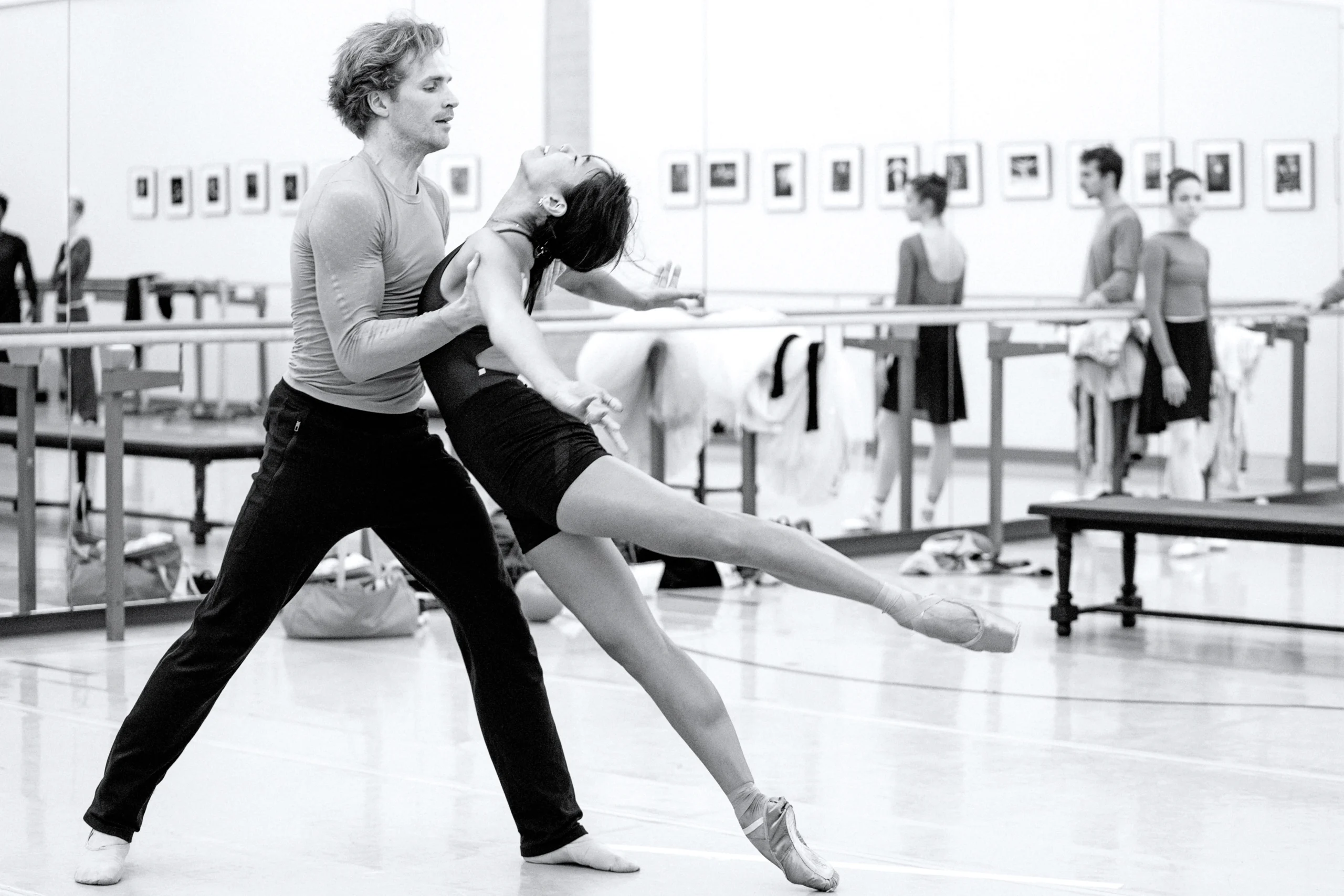 Jenna Savella and Harrison James in rehearsal for Emma Bovary. They dance an emotional pas de deux together in a dance studio; she falls forward into his arms with an emotional look of desperation, and he catches her under her armpits.