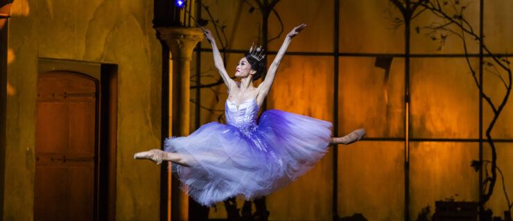 Fumi Kaneko flies through the air in a jubilant saut de chat as The Fairy Godmother in Cinderella.