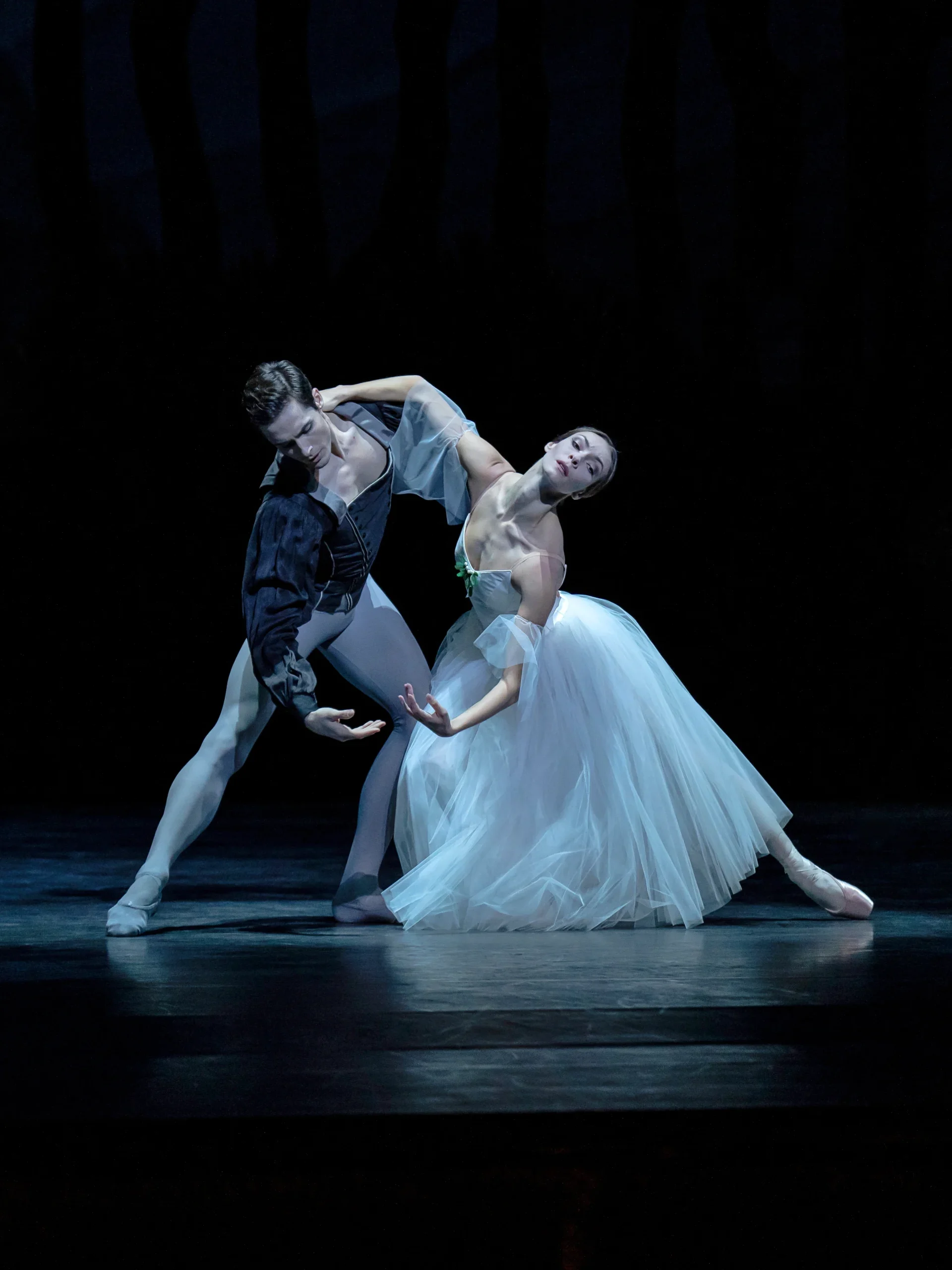 Jacopo Tissi and Olga Smirnova perform as Albrecht and Giselle, embracing each other lightly in a gentle pas de deux.