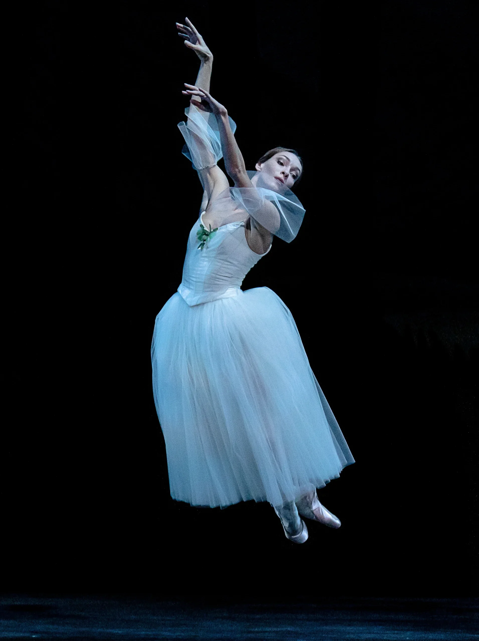 Olga Smirnova, as Giselle, is suspended mid-air in a pas de poisson.