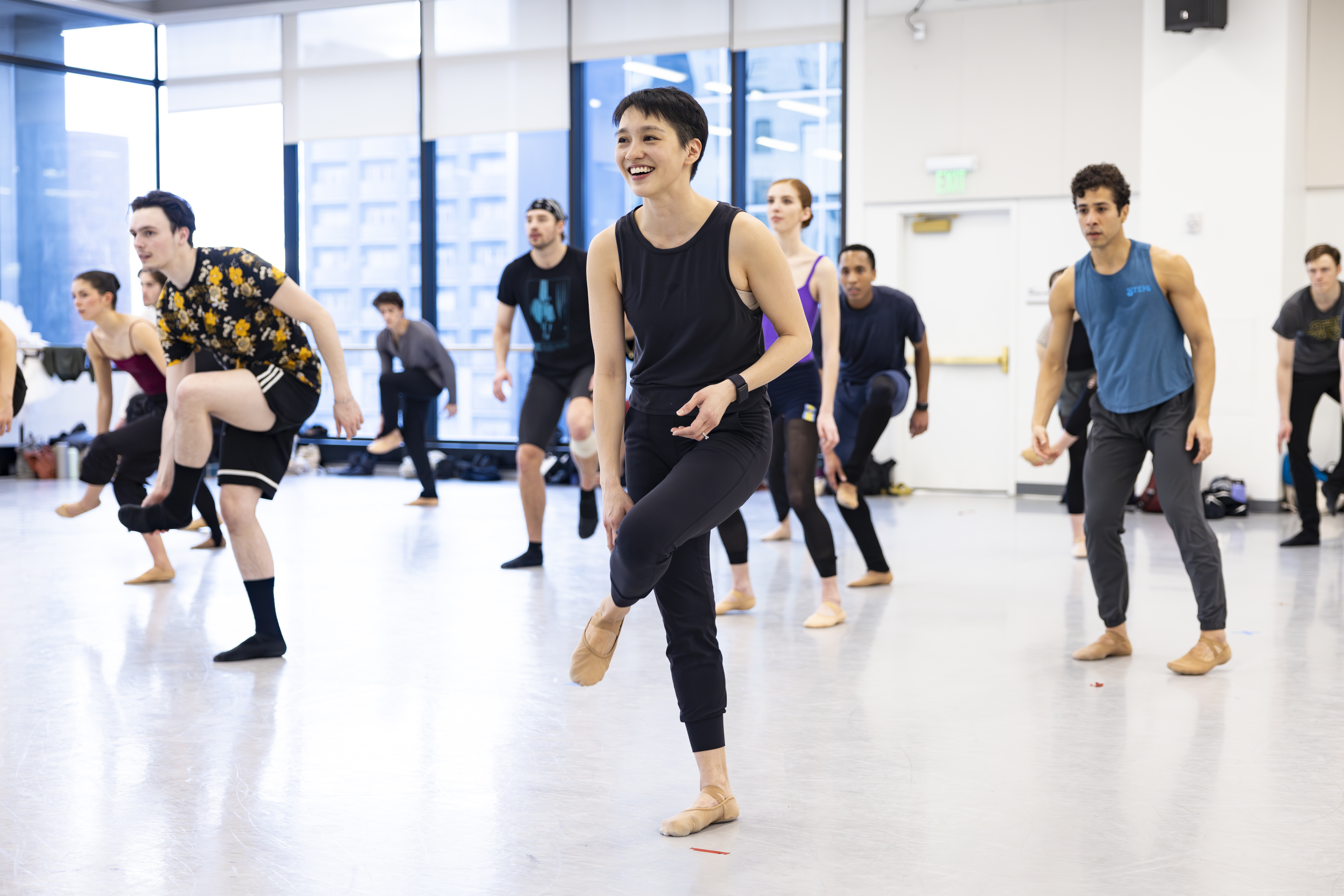 Caili Quan leads a rehearsal at Ballet West, the bright studio packed with dancers in various rehearsal attire.