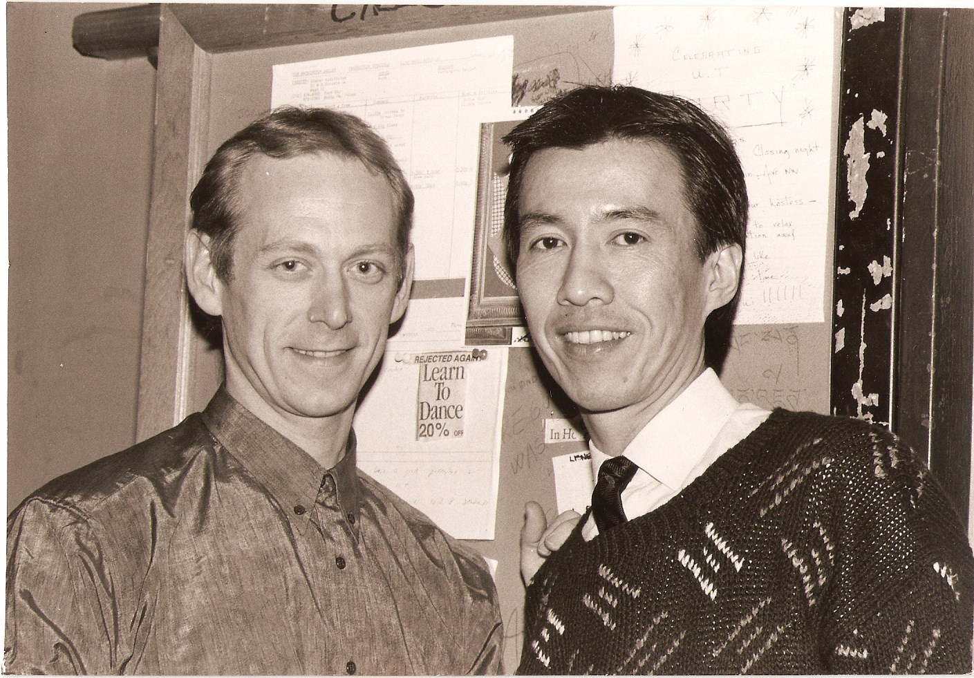 A sepia close-up shows Janek Schergen and Choo San Goh smiling together, pictured chest-up.