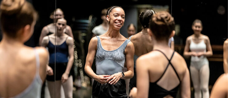 Chyrstyn Fentroy smiles at the front of a studio of dancers.