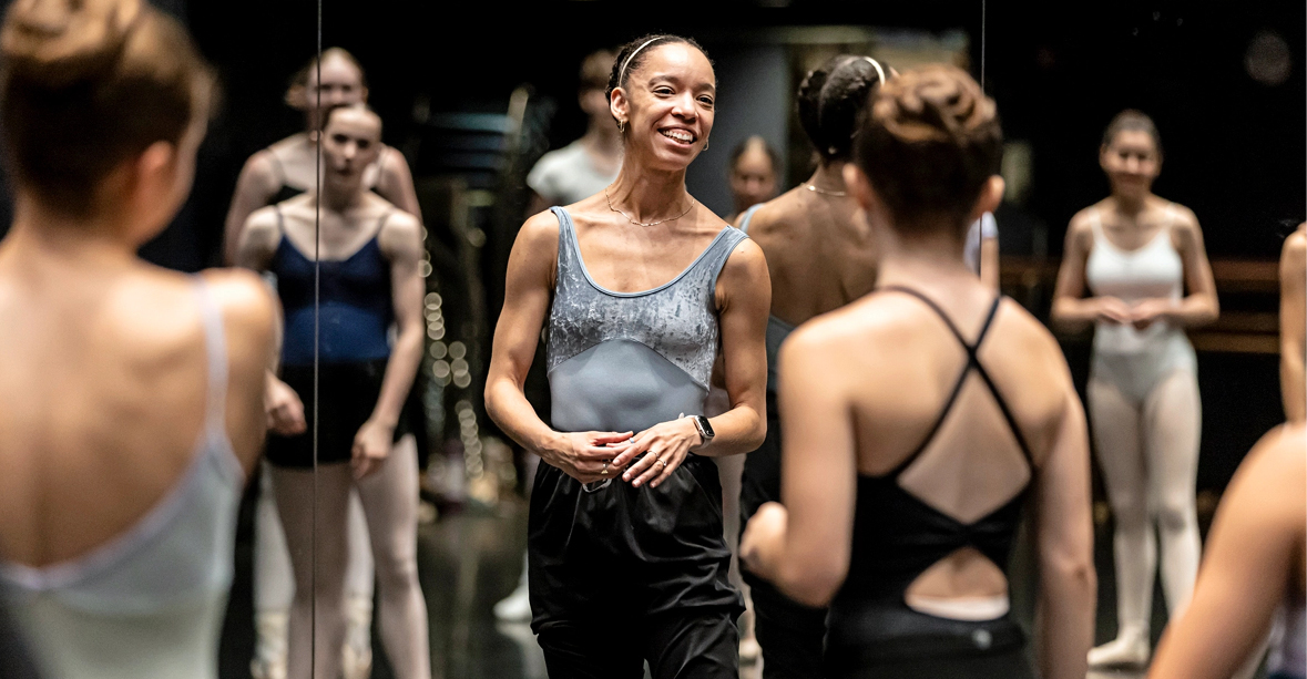 Chyrstyn Fentroy smiles at the front of a studio of dancers.