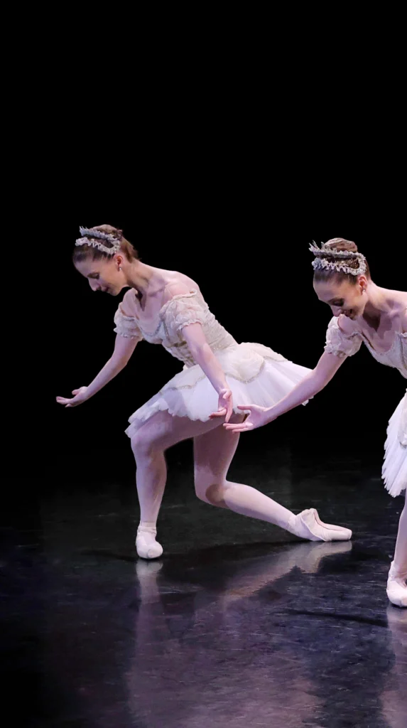 Ellie Prince wears a white tutu and curtsies in a deep b-plus.