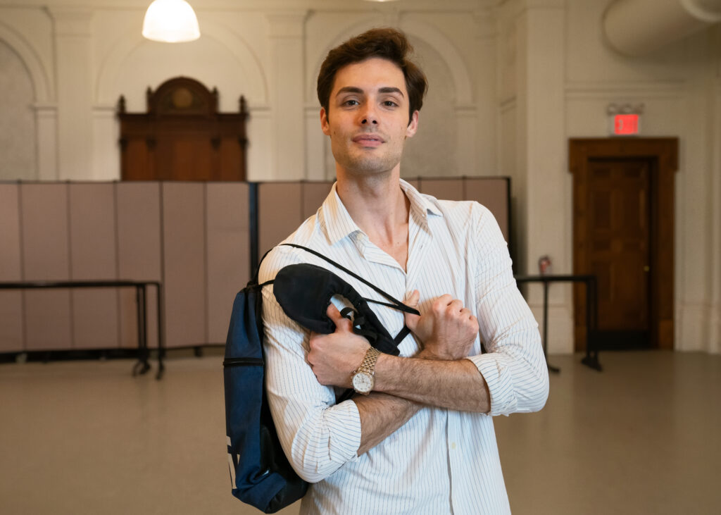 Jacopo Tissi is pictured from the waist up, holding dance bag and black ballet shoes.