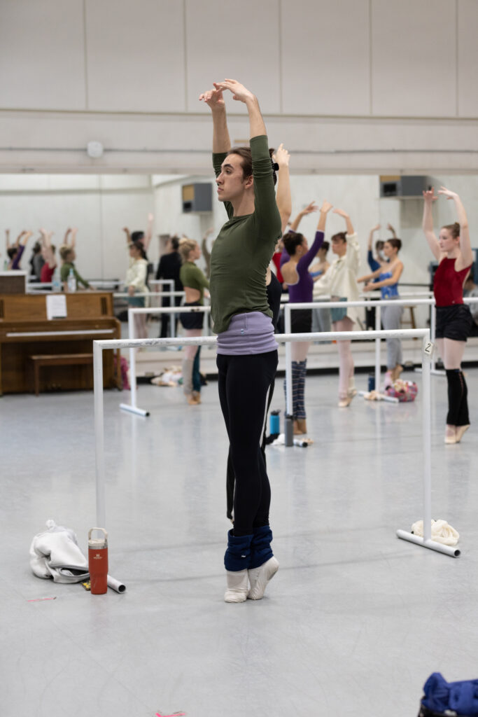 Stanley Cannon stands in sous sus at the barre.