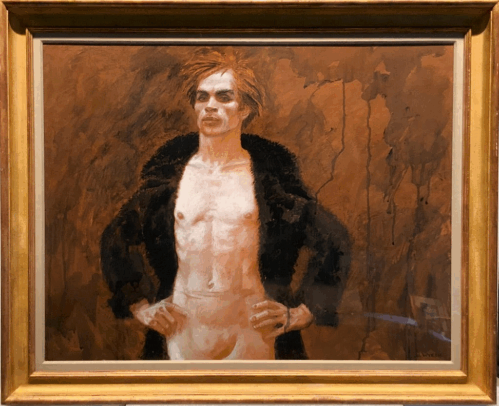 A framed painting of Rudolf Nureyev, who stands with his hands on his hips and looks straight ahead, focused. He wears a large black winter coat, opened to show his bare chest and flesh-tone tights. The background is dark orange and sepia texture, with dark gray and black accents.