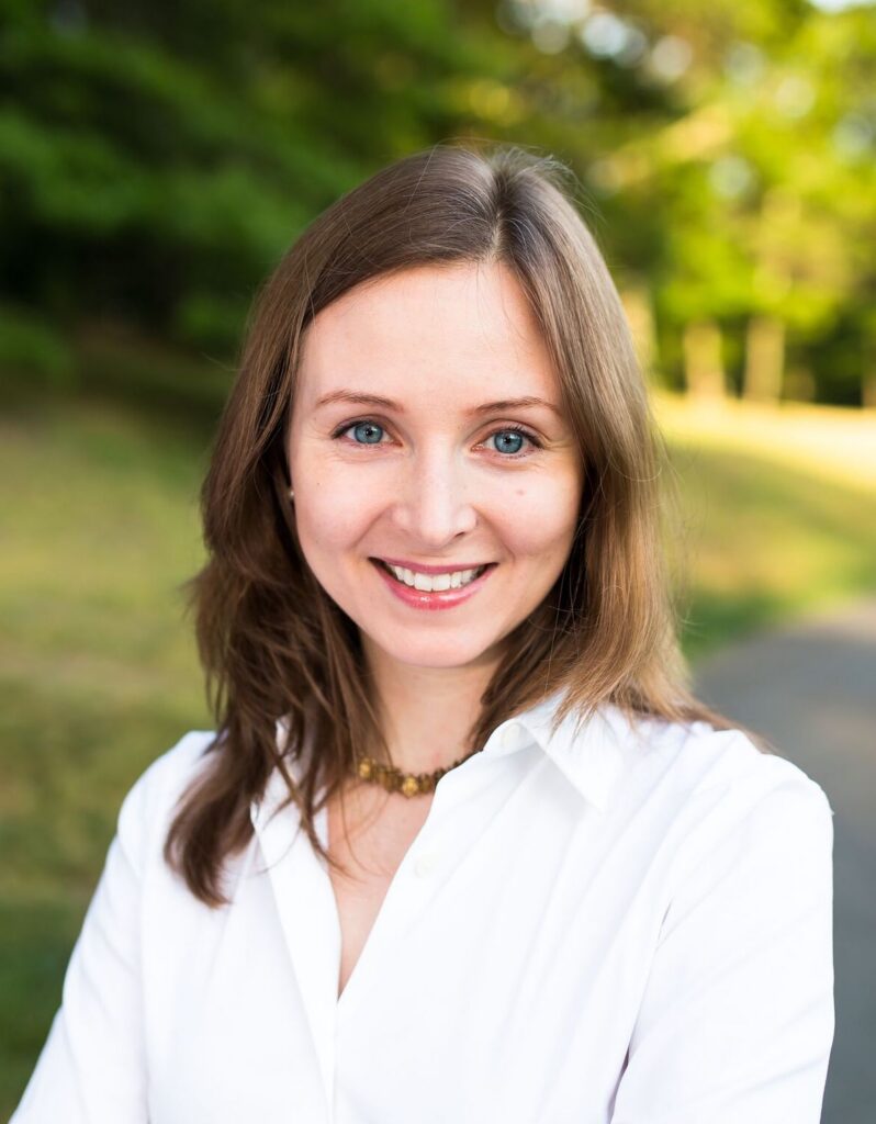 Dr. Miriam Rowan's headshot. She smiles outdoors and wears a white button-down.