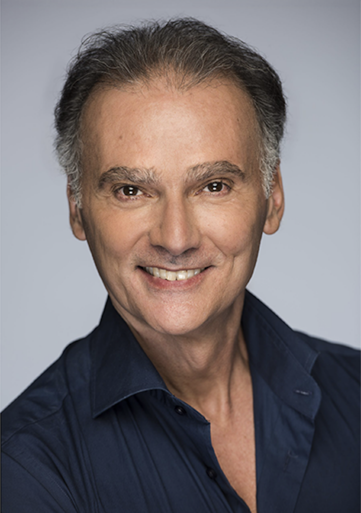 Marcello Angelini's headshot. He wears a navy button-down and smiles at the camera.