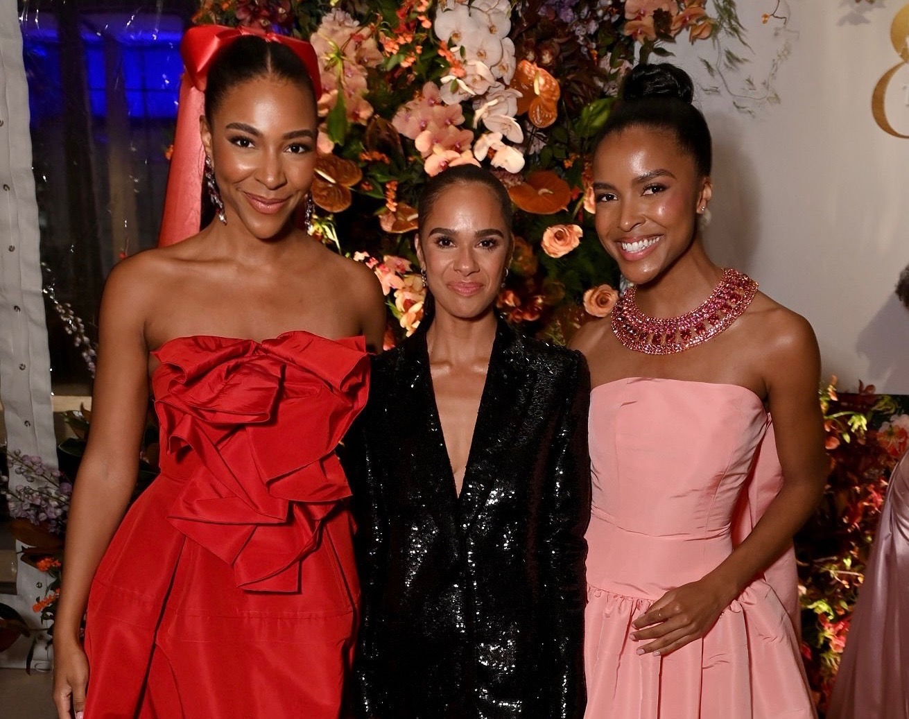 Nia Faith, Misty Copeland, and Justice Faith pose for a photo together wearing formal gala attire. They smile with arms around each other.