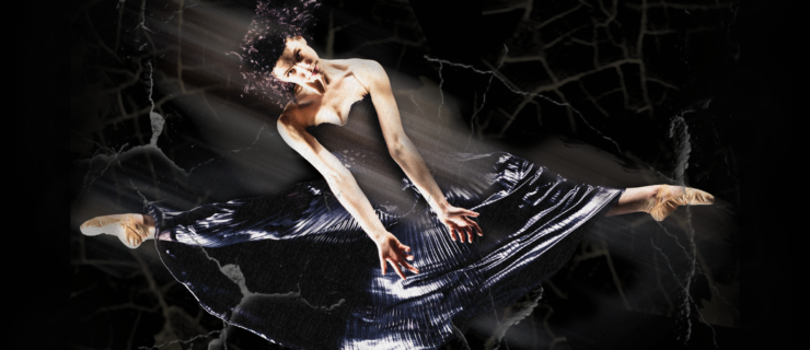 Samantha Sherry is shown midair, in a side leap, against a black, spooky background. Her legs form a straight line. She wears a long black sleeveless dress and skin-tone ballet shoes. She throws her arms down in front of her, parallel with each other and in line with her torso, which she tilts toward the photo's left. Her curly hair is loose and she looks directly into the camera.
